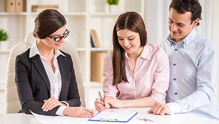 Couple Signing Real Estate Documents Couple Signing Real Estate Documents